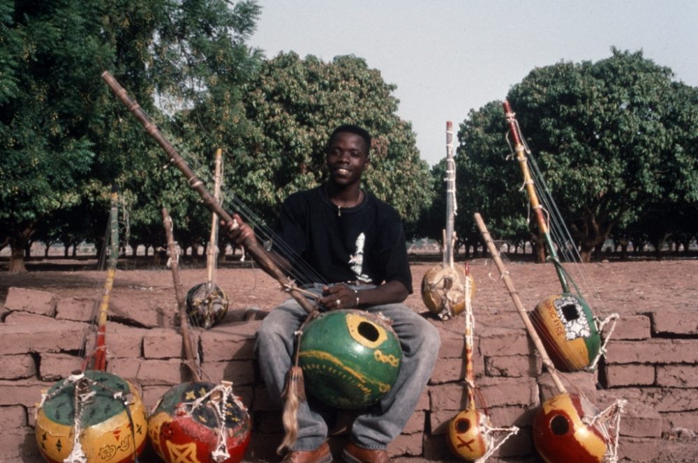 Harouna Samake and kamelé ngonis he made. (Eyre, 1996)