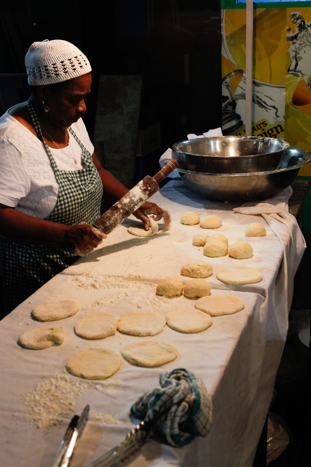 A woman makes fry bakes on the drag