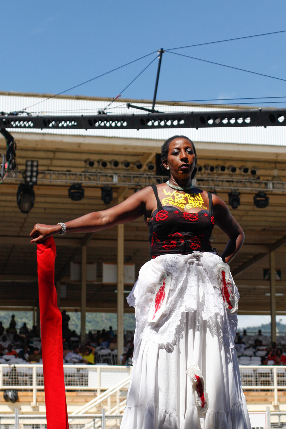 A woman with "Women Are Not Property" written on her chest